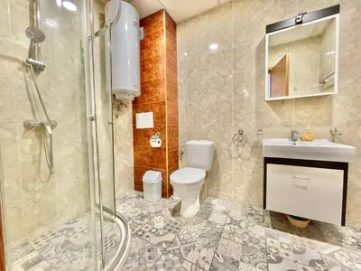 a bathroom with a shower and a toilet and a sink at Prestige Fort Aparthotel - Private apartment - BSR - 2 in Sveti Vlas