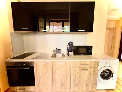 a kitchen with a sink and a microwave at Sea Sun Holiday Apartments Sunny Beach in Sunny Beach