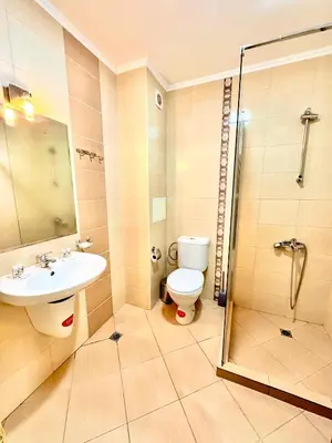 a bathroom with a toilet and a sink and a shower at Sea Sun Holiday Apartments Sunny Beach in Sunny Beach