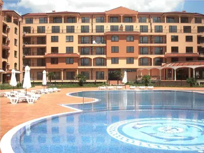 a large hotel with a swimming pool in front of a building at Menada Diamant Apartments in Sunny Beach