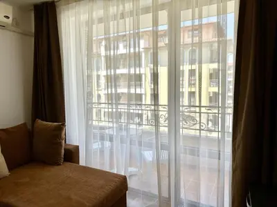 a room with a window with a view of a building at Menada Diamant Apartments in Sunny Beach