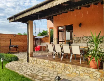 a patio with chairs and a table on a house at Casa Soleada in Bliznatsi
