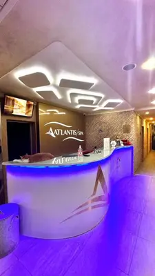 a bar with purple lights in a room at Апартамент БАНГЕВИ in Burgas City