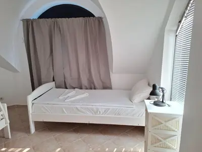 a white bed in a room with a window at MAGNOLIA Apartments in Ravda