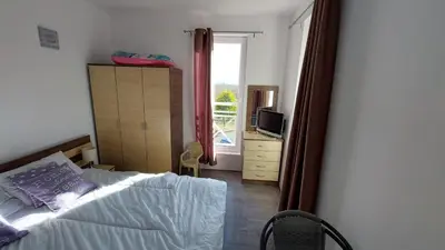 a bedroom with a bed and a window at Sunny Day 6 , Sunny beach, 3-Стаен апартамент in Tŭnkovo
