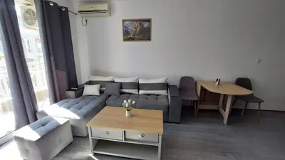 a living room with a couch and a table at Sunny Day 6 , Sunny beach, 3-Стаен апартамент in Tŭnkovo