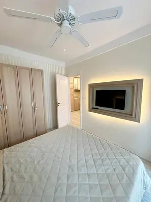 a bedroom with a bed and a ceiling fan at VIP Harmony Suites 20 SVETY VLAS in Sveti Vlas