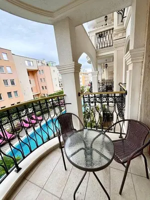a balcony with a glass table and chairs on a balcony at VIP Harmony Suites 20 SVETY VLAS in Sveti Vlas