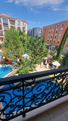 a balcony with a view of a pool and buildings at A wonderful vacation home in Sunny Beach