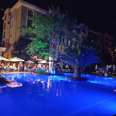 a swimming pool at night with blue lights at Cascadas Family Studio Komfort dla Dwojga lub Rodziny in Sunny Beach