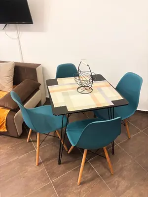 a dining table with four chairs and a couch at Cascadas Family Studio Komfort dla Dwojga lub Rodziny in Sunny Beach