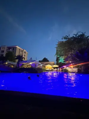 a pool of water with blue lights at night at Cascadas Family Studio Komfort dla Dwojga lub Rodziny in Sunny Beach
