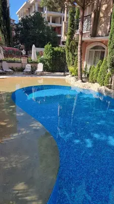a large blue swimming pool in front of a building at Romans Marin in Sunny Beach