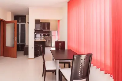 a kitchen and dining room with a table and chairs at Apartment Patriarh Evtimiy in Burgas City