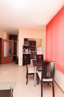 a kitchen and dining room with a table and chairs at Apartment Patriarh Evtimiy in Burgas City