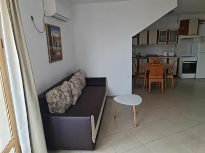 a living room with a couch and a table at Apartment Lermontov in Burgas City