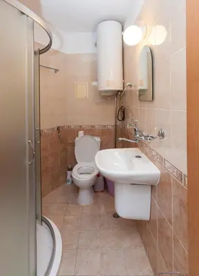 a bathroom with a toilet and a sink at Apartment Lermontov in Burgas City