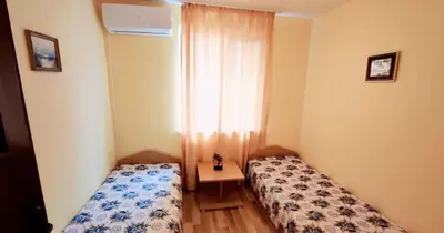 a small room with two beds and a table at Апартамент Сиракови Черноморец in Chernomorets