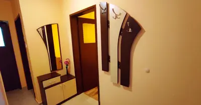 a room with a door and a mirror on the wall at Апартамент Сиракови Черноморец in Chernomorets