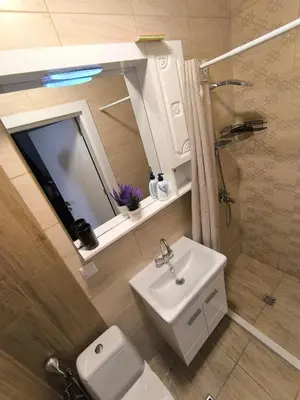 a bathroom with a sink and a shower and a toilet at Apartment Oborishte in Burgas City