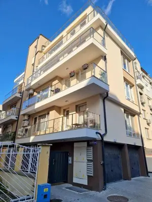 an apartment building with a balcony on the side at Apartment Oborishte in Burgas City