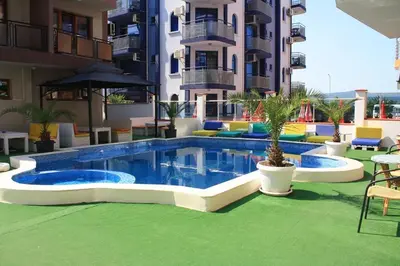 a swimming pool in front of a building at Mirage Family Hotel in Primorsko