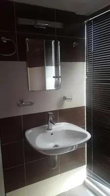 a bathroom with a white sink and a mirror at Mirage Family Hotel in Primorsko