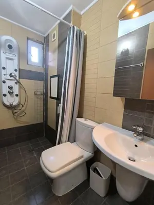a bathroom with a toilet and a sink and a shower at Apartment Rilska - Center and Sea Garden in Burgas City