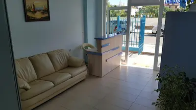 a living room with a couch in front of a door at Ivanovi Guest House in Primorsko