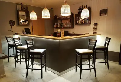 a bar with a row of stools in a restaurant at Seaside 1 BR Apartment with balcony, max 4 Guests in Sunny Beach