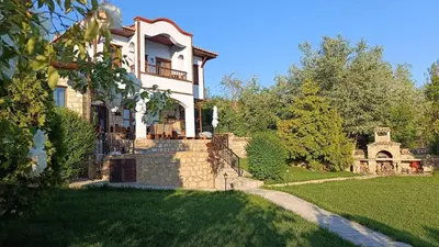 a large house with a green lawn in front of it at къщи за гости villa Momino in Avren