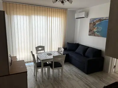 a living room with a table and a couch at Obzor in Obzor