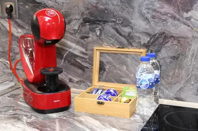 a red blender next to a wooden box with a mirror at Апартамент за гости Мечта Лазур in Burgas City