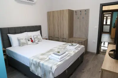 a bedroom with a bed with towels on it at Апартамент за гости Мечта Лазур in Burgas City