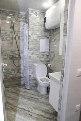 a bathroom with a toilet and a shower and a sink at Апартамент за гости Мечта Лазур in Burgas City