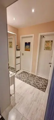 a room with a hallway with two doors and a rug at 1 bedroom Harmony Monte Carlo in Sunny Beach