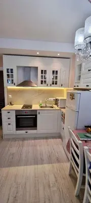 a kitchen with white cabinets and a stove top oven at 1 bedroom Harmony Monte Carlo in Sunny Beach