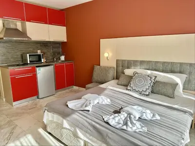 a bedroom with a large bed with towels on it at River Park Menada Apartments in Sunny Beach
