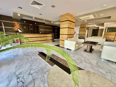 a lobby of a hotel with a table and chairs at River Park Menada Apartments in Sunny Beach