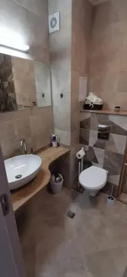 a bathroom with a white sink and a toilet at Ах, морето 2 in Burgas City