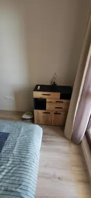 a bedroom with a bed and a dresser and a window at Ах, морето 2 in Burgas City