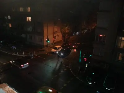 a city street at night with a green traffic light at Apartment Nova in Burgas City
