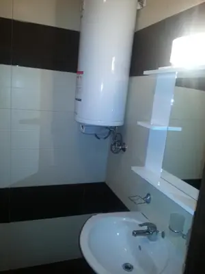 a bathroom with a white sink and a mirror at Apartment Nova in Burgas City