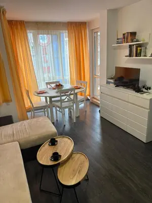 a living room with a couch and a table at Apartment 4 Plus Burgas in Burgas City