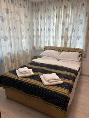 a bedroom with a bed with towels on it at Apartment 4 Plus Burgas in Burgas City