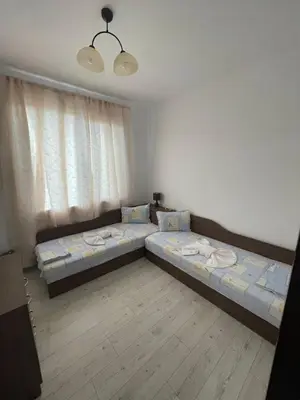 a bedroom with two beds and a window at Вили Панорама 2 in Chernomorets