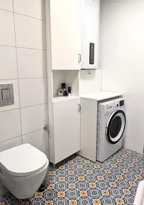 a bathroom with a washing machine and a toilet at Seaside luxury residence in Varna City