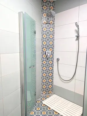 a bathroom with a shower with a bench in it at Seaside luxury residence in Varna City