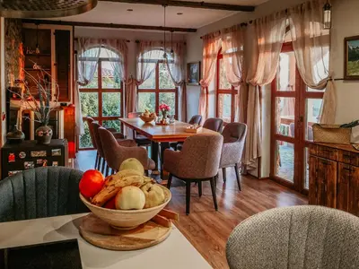 a dining room with a table and chairs at къща за гости villa Jurta in Avren