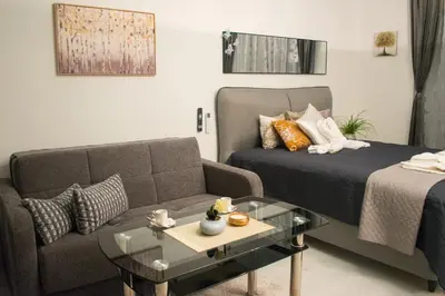 a living room with a bed and a couch at Nelly's Place 10 in Shkorpilovtsi